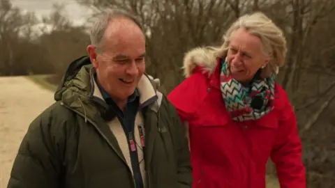 Roger Finn walking with Sally Taylor in the New Forest