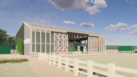 RH Partnership/CoFarm An illustrative design of what the community barn could look like from the outside. It is a large beige rectangular structure with sliding doors and a pointed roof.
