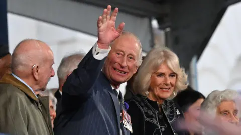 Getty Images Britain's King Charles III waves as he arrives for a celebratory concert to mark the 80th anniversary of VE Day