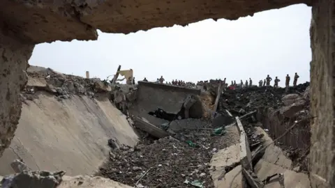 AFP Soldiers looking at a crater at the army deport in N'Djamena lasts at a military ammunition depot in N'Djamena, Chad June 19, 2024.