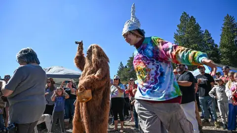 Anjali Sharif-Paul, The Sun/SCNG via Getty Images Collin Ware dances around Bigfoot during the first annual Bigfoot Festival, hosted at the Running Springs Farmers Market on Saturday, Oct. 11, 2025.