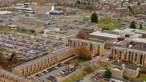 A general view of The Royal Shrewsbury Hospital on November 20, 2019 in Shrewsbury, England. We can see lots of buildings and some car parks. 