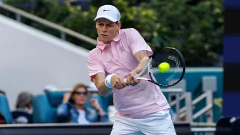 Jannik Sinner plays a backhand shot