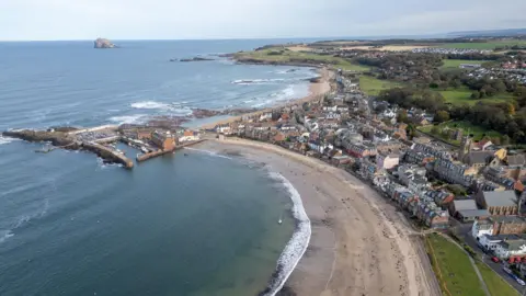 An aerial view of North Berwick, a seaside town in East Lothian, on a clear bright day.