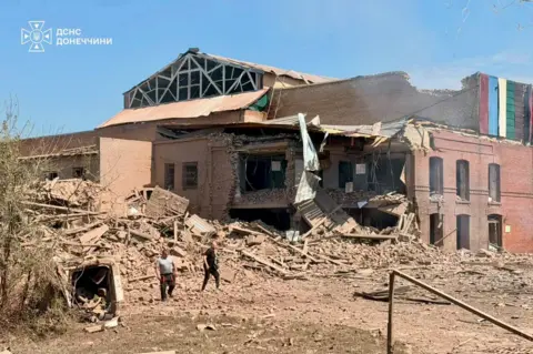 Ukrainian President Zelensky The damage to a building and a pile of rubble at the scene of a Russian missile strike just outside of Kyiv