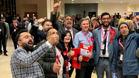 Shariqua Ahmed/BBC Labour Party members celebrating winning seats from Peterborough's Tories on 2 May
