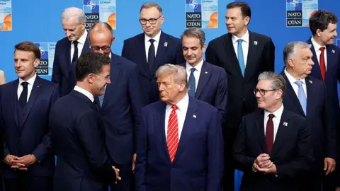Getty Images Trump stands alongside Nato allies at a Nato event. 