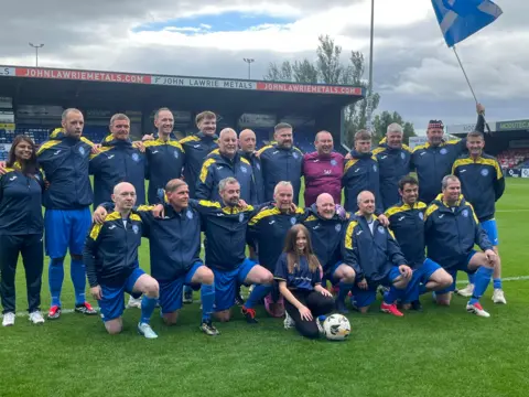 Group of woman and a man with Scotland flag.
