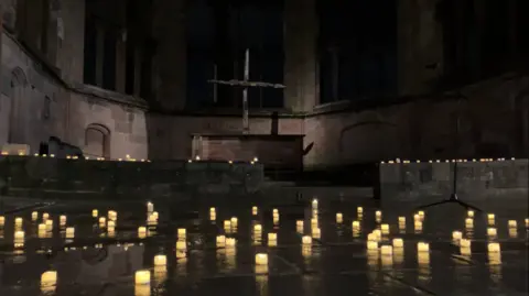 BBC Lit candles on the floor on ruins of the Coventry Cathedral for the blitz memorial