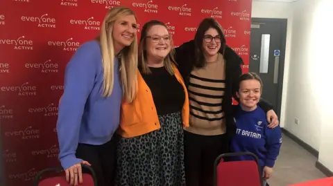 Everyone Active The two guest stars posing for a photo with two smiling women