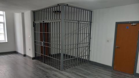 Jail cell within studio apartment