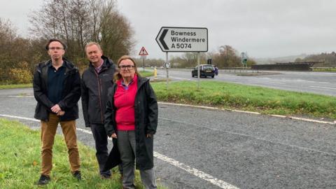 Tim Farron and councillors Steve Bavin and Janet Battye on the A590 at the Gilpin Bridge Junction