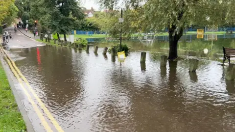 The road next to Aristotle recreation ground and part of the field is underwater.