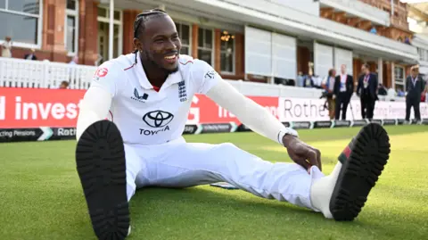 England fast bowler Jofra Archer sits in front of the Lord's pavilion after victory over India