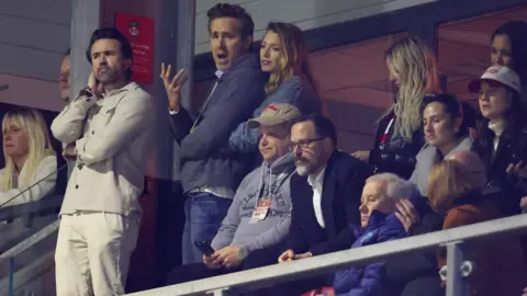 Reuters Pained expressions on the faces of Rob Mac, Ryan Reynolds and Blake Lively as they watch Wrexham lose to Chelsea in a cup match last month