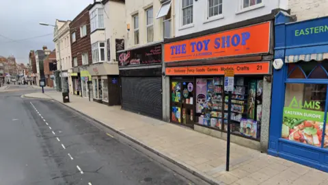 Google A street view image of Kerrison Toys on King Street in Great Yarmouth. The store has an orange facade and the words "The Toy Shop" are written in blue