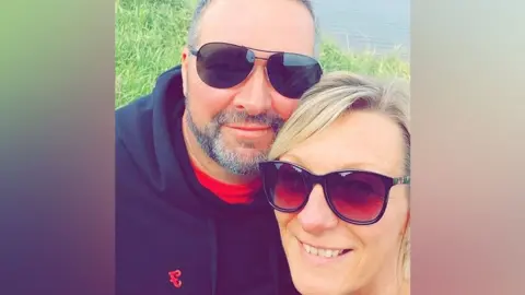 WestYorkshire Police Man and woman in sunglasses smile for camera