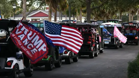 Getty Images Golf carts line the street during a tailgate victory party and golf cart rally to celebrate the election of former U.S. President Donald Trump in November 2024