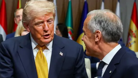 U.S. President Donald Trump speaks with Canada's Prime Minister Mark Carney at a meeting of the North Atlantic Council (NAC) during the NATO leaders' summit in Ankara, Turkey, July 8, 2026. 