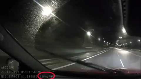 Kent Police A screenshot of dashcam footage which has a red cirlce around the speed, which says 126mph.