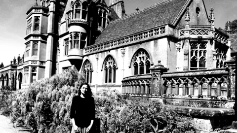 Angela Tomaski A black and white image of Angela Tomaski on the grounds of Tyntesfield Victorian Gothic Revival house.