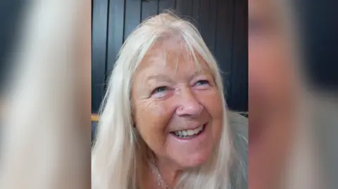 Libby Romain Libby smiles and looks slightly to the side of the camera