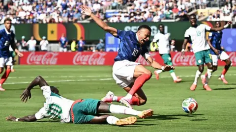 Senegal's Sadio Mane challenges France's Kylian Mbappe in the penalty area leading to a VAR review
