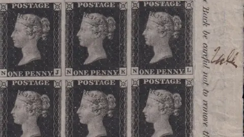 An image of six stamps which the Queen's head on them. Three of them say 'ONE PENNY' and the other three say 'POSTAGE'. There is writing on the the right hand side of part of a sentence which says 'Back be careful not to remove the'. Beside that to the right, there is a brown signature.