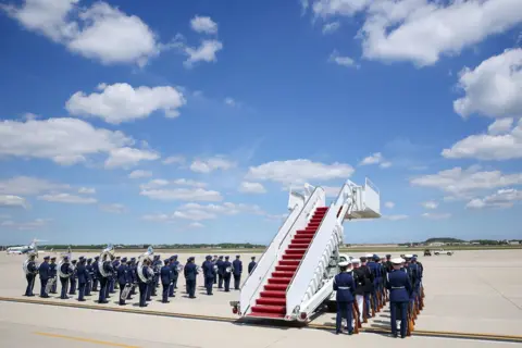Getty Images The U.S. Air Force band and military honor guard prepare ahead of the arrival of King Charles III and Queen Camilla on day one of the State Visit on April 27, 2026 at Joint Base Andrews, Maryland. 