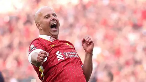 Arne Slot celebrates Liverpool's victory and confirmation of winning the Premier League title after the Premier League match against Tottenham Hotspur at Anfield
