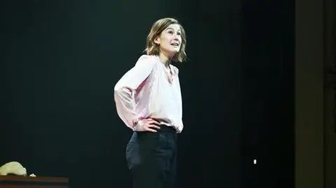 Getty Images Rosamund Pike bows at the curtain call during the press night performance of Inter Alia at Wyndham's Theatre on April 7, 2026 in London
