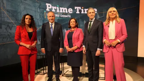 PA Media Tanaiste and Fianna Fail Leader Micheal Martin, Sinn Fein leader Mary Lou McDonald and Taoiseach and Fine Gael leader Simon Harris with presenters Miriam O'Callaghan (right) and Sarah McInerney during the final TV leaders' debate, at RTE studios in Donnybrook, Dublin, ahead of the General Election on November 29. Picture date: Tuesday November 26, 2024. PA Photo.