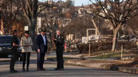 Trump tours the damage with Melania