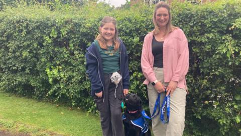Izzy Bernice and her mother with their black Labrador Jessie