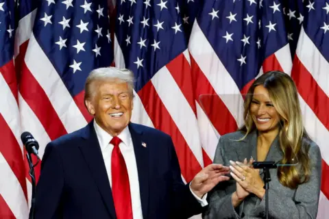 Getty Images A smiling Donald and Melania Trump during an election night event at the Palm Beach Convention Center in Florida on 6 November 2024