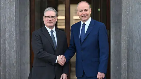 Getty Images Prime Minister Keir Starmer and Taoiseach Micheál Martin shake hands prior to a UK Ireland Summit in 2026.