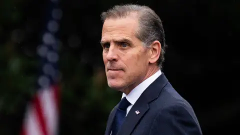 Hunter Biden in a suit looking past the camera