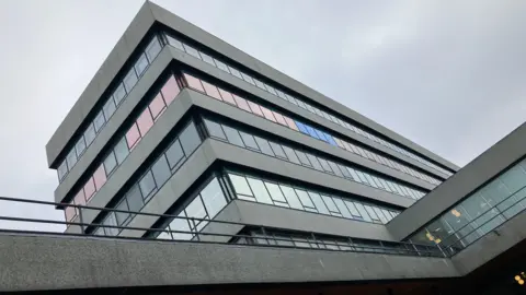 BBC A flat roofed council building made of grey concrete and glass