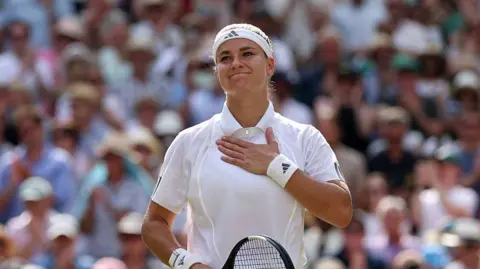 Karolina Muchova acknowledges the crowd at Wimbledon in 2026