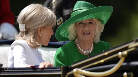 WPA Pool/Getty Images Queen Camilla (right) and Brigitte Macron are seen during a carriage procession to Windsor Castle.