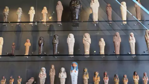 Getty Images Dozens of statuettes on display behind glass