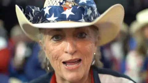 Republican supporter wearing a colourful hat 