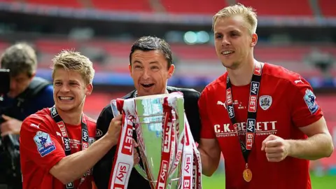 Getty Images Lloyd Isgrove, manager Paul Heckingbottom and Marc Roberts celebrate after winning the Sky Bet League One Play Off Final between against Millwall at Wembley Stadium on May 29, 2016.