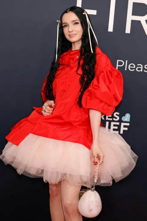 Getty Images Poppy posing on the red carpet at the Grammys