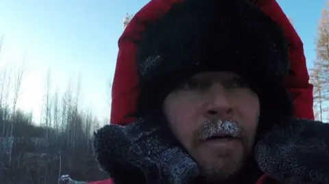 Instagram/Karl Bushby Pictured is Karl Bushby dressed in a thick coat