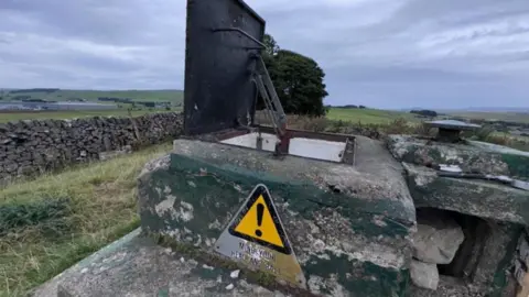 SDL The concrete entrance to the bunker in a field near Buxton