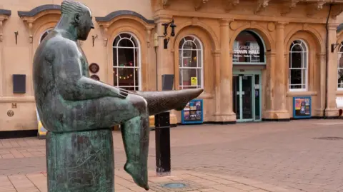 Loughborough town centre with the Sockman statue and town hall behind it