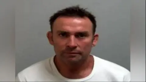 Essex Police David Buisson wearing a white T-shirt