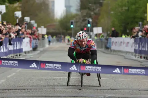  Manchester Marathon Bret Crossley passes the finish line during the 2024 Manchester Marathon