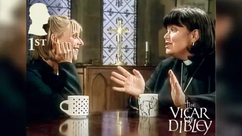 Iconic scene of Alice played by Emma Chambers with a blonde bob and Geraldine Granger starring Dawn French with a dark haired bob and wearing a vicars outfit.